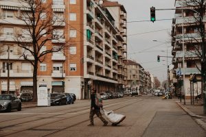 man in black jacket and blue denim jeans walking on sidewalk during daytime — Illinois workers compensation attorney Chicago