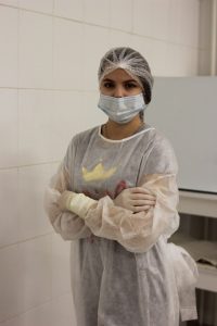 a woman wearing a surgical mask and gloves
